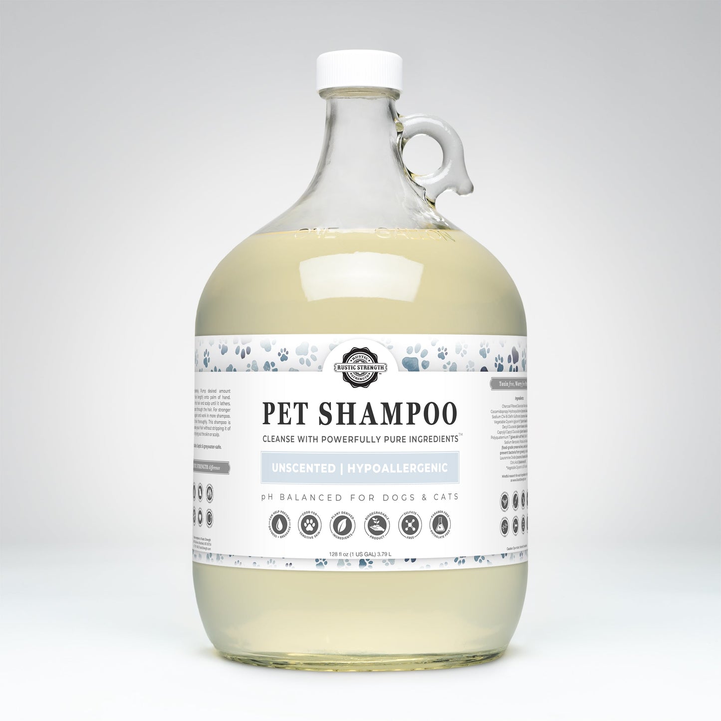 Rustic Strength Pet Shampoo | Soothing & Deodorizing | Unscented is a large, clear jug with handle, pH balanced for dogs and cats, hypoallergenic, non-toxic, and made with plant-based ingredients. Features paw print icons on the label.