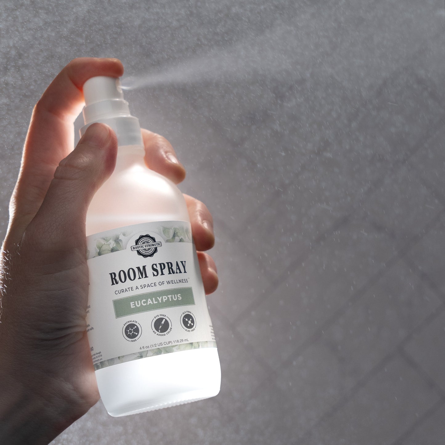 Rustic Strength eucalyptus room spray bottle with a clear label, designed for freshening indoor spaces with natural eucalyptus scent.