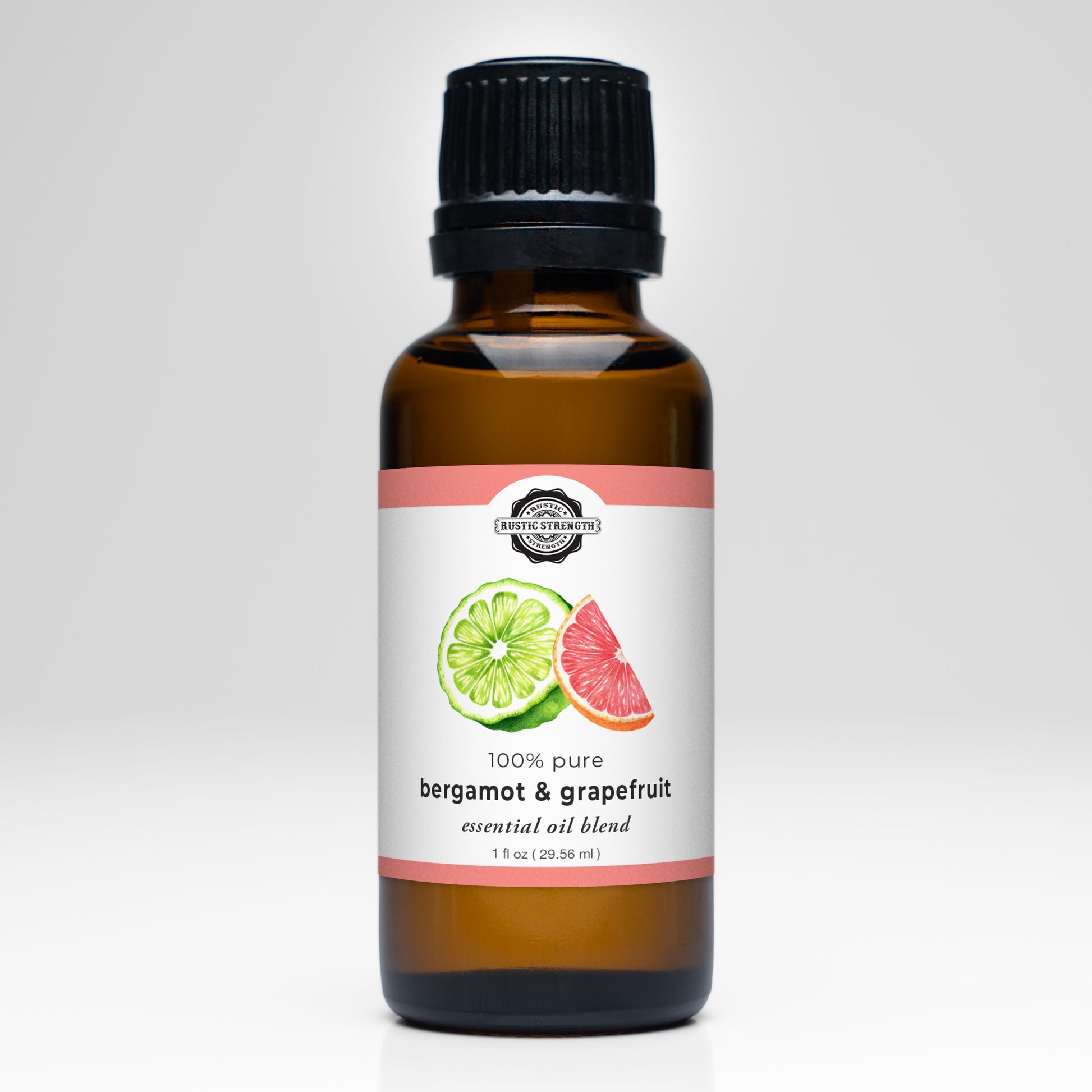 A brown glass bottle with a black cap labeled “Rustic Strength Bergamot & Grapefruit Essential Oil Blend,” featuring citrus illustrations. Ideal for aromatherapy or fresh laundry scents. White background.