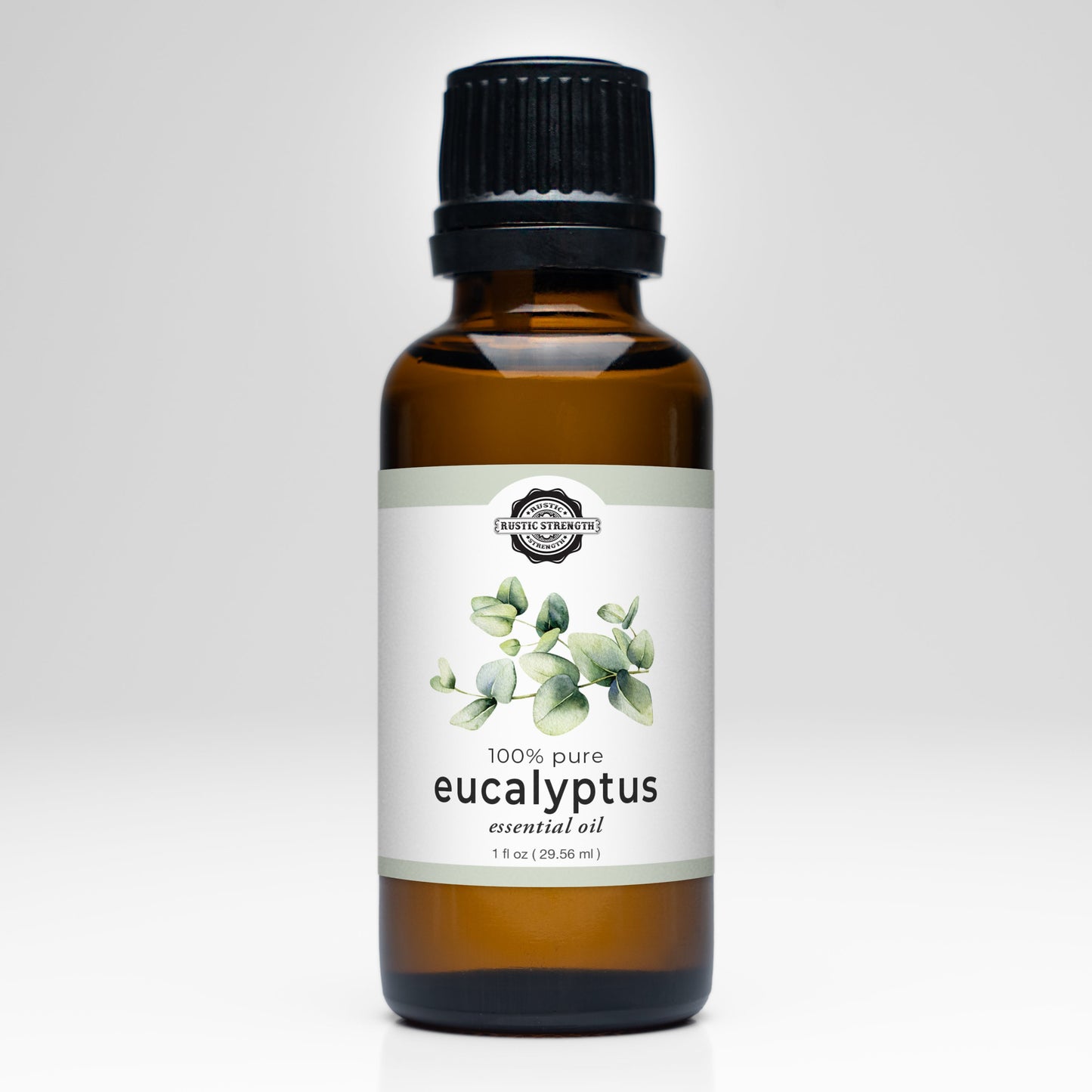 A brown glass bottle with a black cap labeled “Rustic Strength Eucalyptus Essential Oil,” featuring eucalyptus leaf art and “100% pure,” ideal for aromatherapy, shown on a white background.