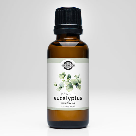 A brown glass bottle with a black cap labeled “Rustic Strength Eucalyptus Essential Oil,” featuring eucalyptus leaf art and “100% pure,” ideal for aromatherapy, shown on a white background.