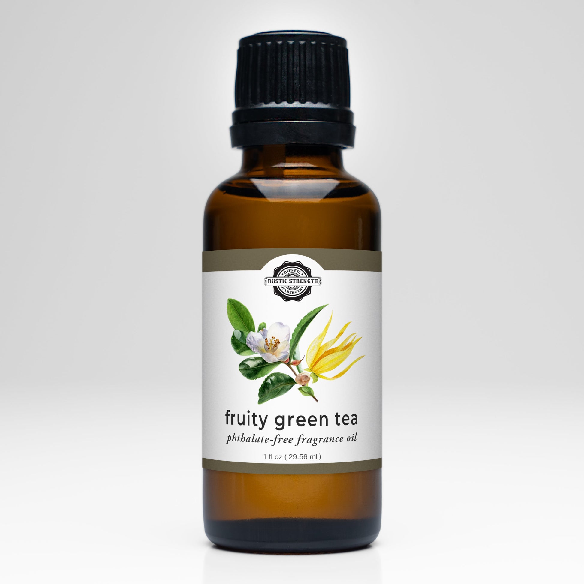 A brown glass bottle with a black cap labeled Fruity Green Tea Phthalate-Free Fragrance Oil by Rustic Strength, featuring an illustration of tea leaves, white flowers, and yellow blossoms on the front.