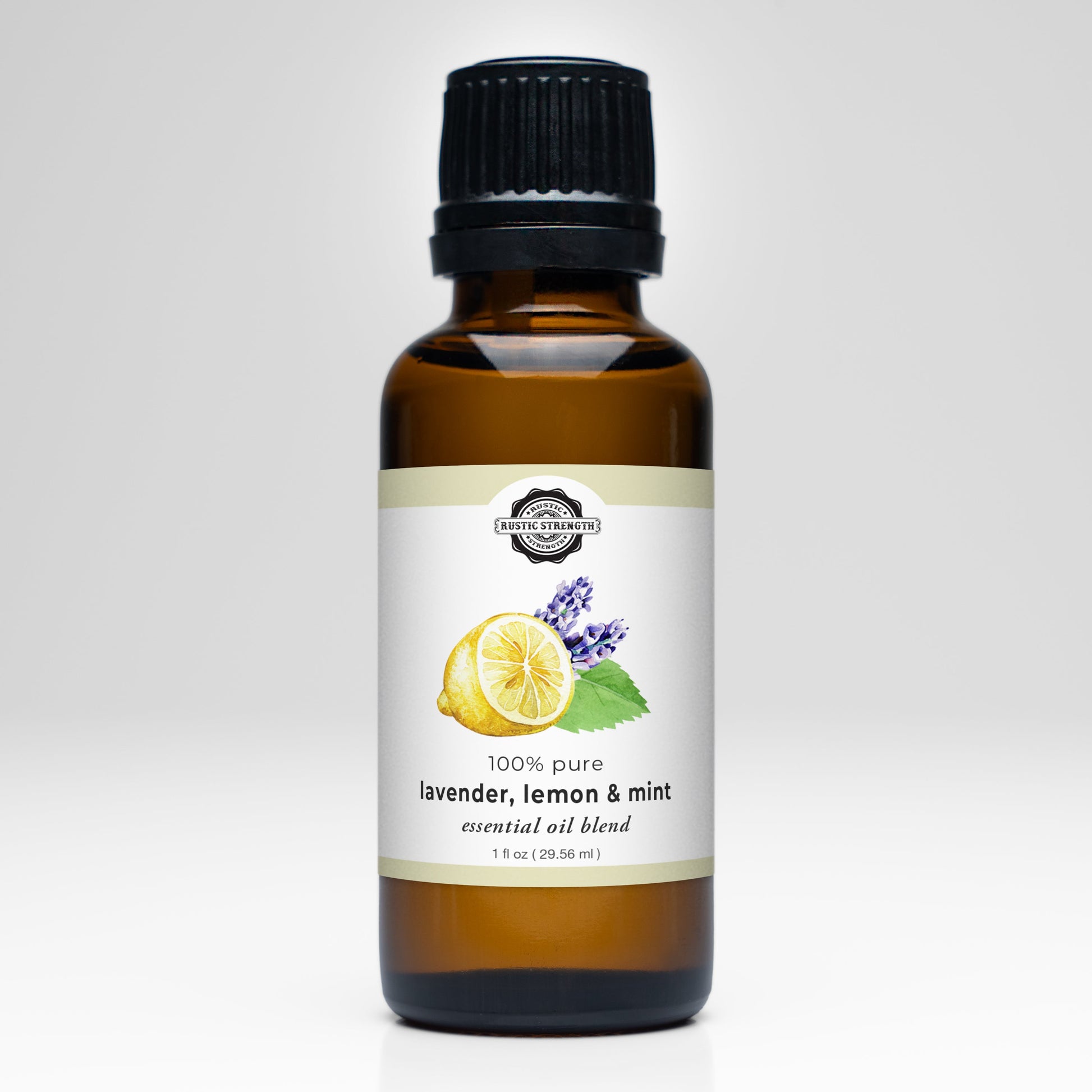 A brown glass bottle with a black cap contains Rustic Strength’s Lavender, Lemon & Mint Essential Oil Blend. The label features images of a lemon slice, lavender, and mint leaves, plus “100% pure” and “essential oils blend.”.