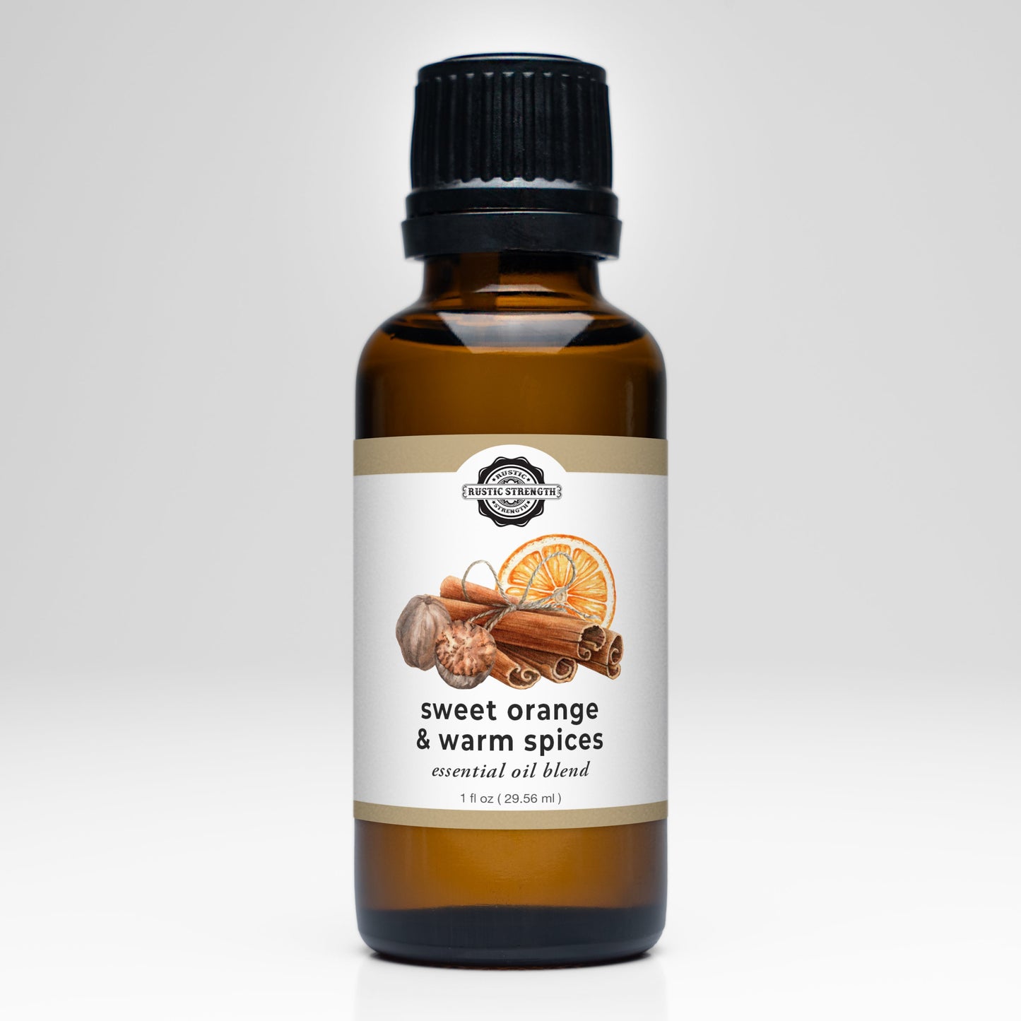 A brown glass bottle with a black cap, labeled Rustic Strength Sweet Orange & Warm Spices Essential Oil Blend. The label features orange slices, cinnamon sticks, and cloves on white—ideal for aromatherapy or adding scent to laundry.