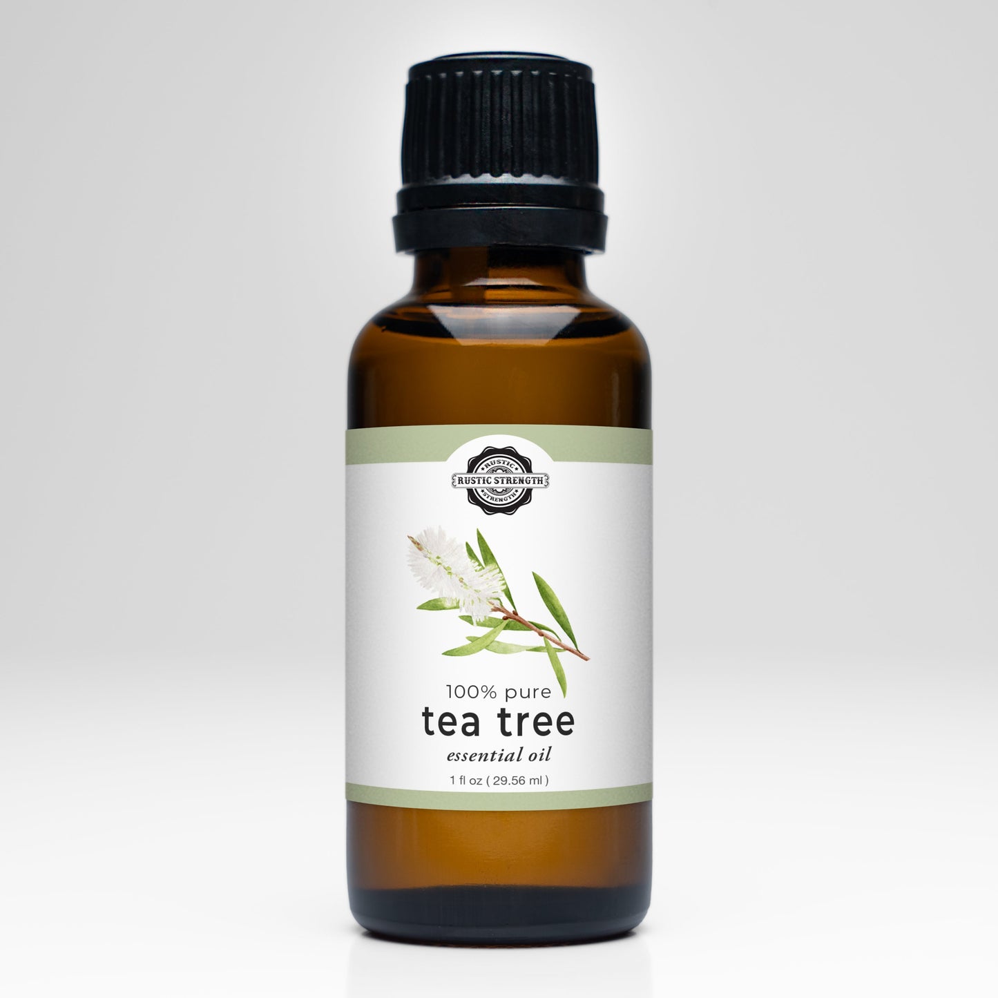A brown glass bottle with a black cap, labeled Tea Tree Essential Oil by Rustic Strength, features tea tree leaves and a white flower—ideal for aromatherapy and other essential oil uses.
