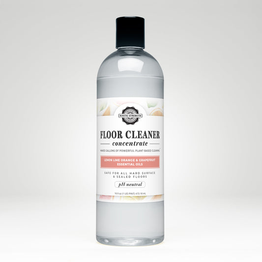 Rustic Strength Floor Cleaner Concentrate soap in 16 oz bottle with flip-top spout, citrus scents of lemon, lime, orange, and grapefruit.