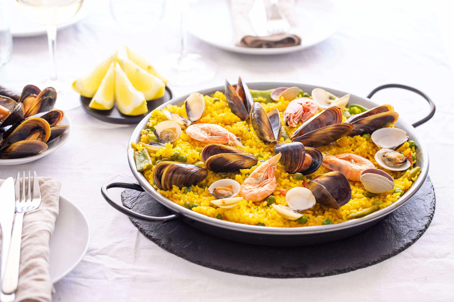 Premium Saffron Threads from Vanilla Bean Kings shown in a seafood paella dish, highlighting vibrant orange-red saffron strands.