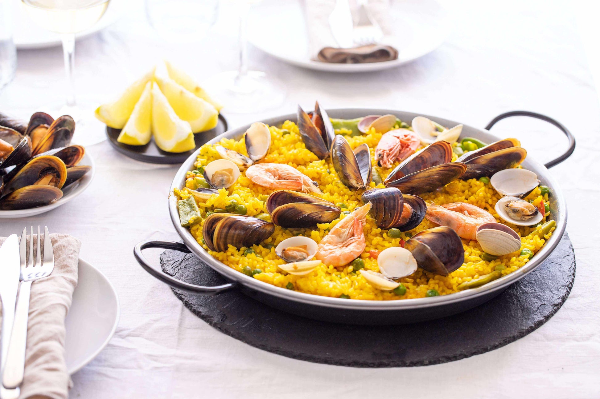 Premium Saffron Threads from Vanilla Bean Kings shown in a seafood paella dish, highlighting vibrant orange-red saffron strands.