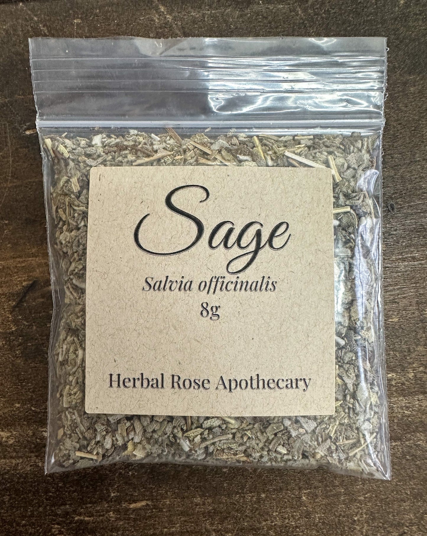 Dried sage herb from HerbalRoseApothecary in an 8g package, showing fresh green leaves and textured dried herbs.