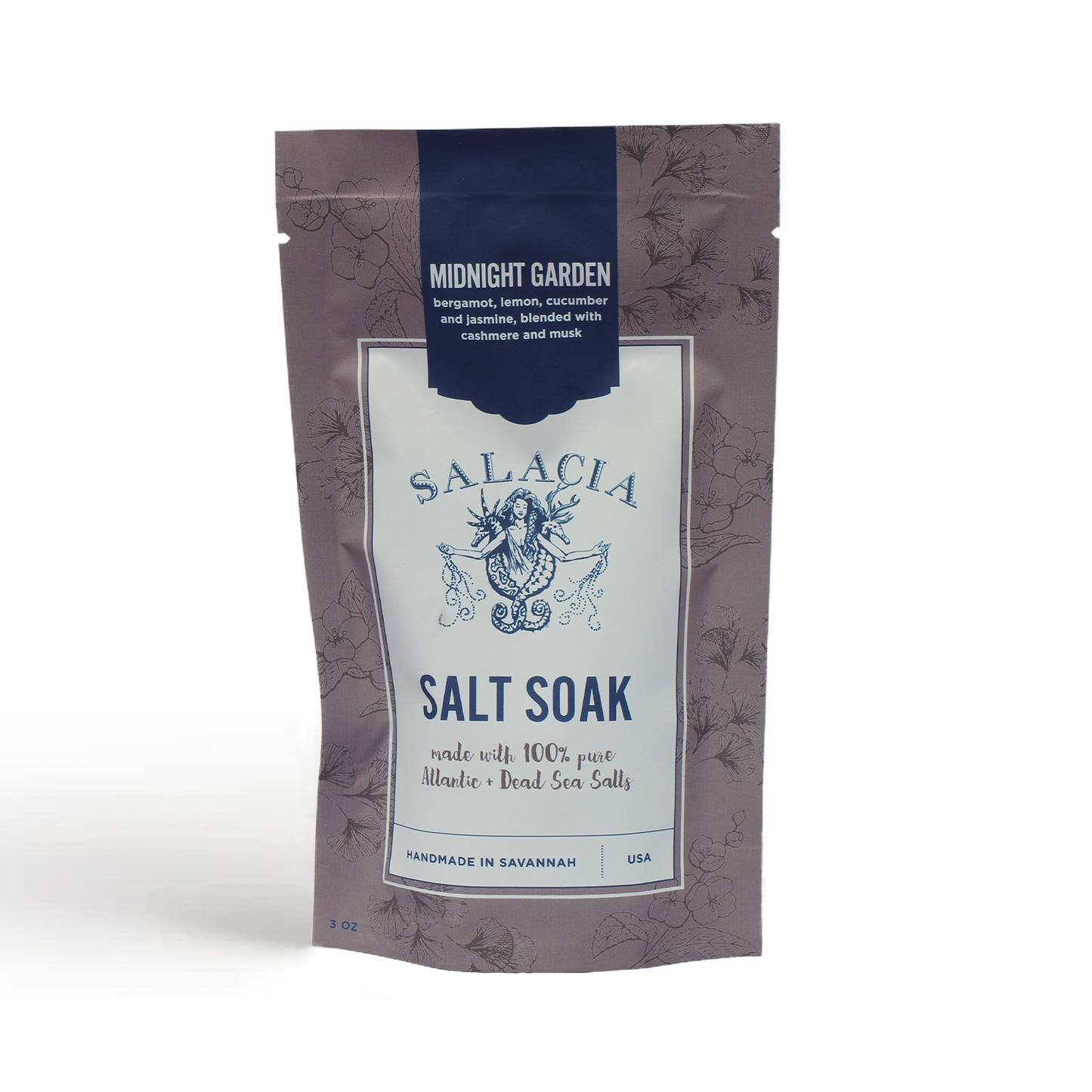 A stand-up pouch labeled "Midnight Garden Small Salt Soak" by Salacia Salts, with mermaid and botanical art, features a relaxing blend of Atlantic and Dead Sea salts plus natural essential oils. Handmade in Savannah, USA.