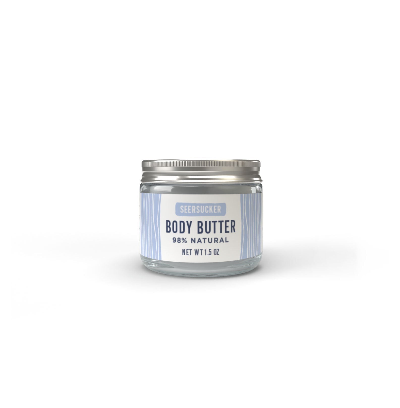 A clear glass jar with a silver lid, labeled Salacia Salts Seersucker Body Butter, 98% natural, Net Wt 1.5 oz, features light blue and white stripes and a clean cotton-scented body butter formula.