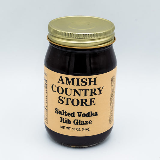 16 oz jar of Amish Country Store Salted Vodka Rib Glaze in a clear glass can with a label featuring product details.