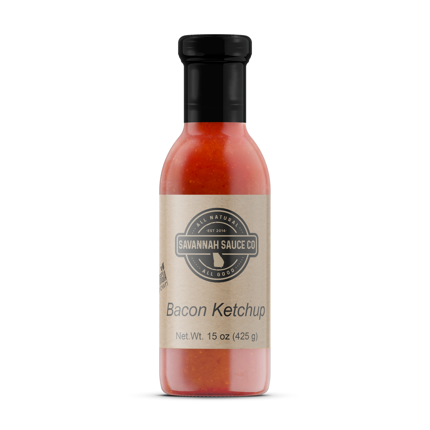 A 15 oz bottle of SavannahSauceCompany Bacon Ketchup, made with savory bacon and tomato puree, features a beige label, black cap, and the text “All Natural,” “Savannah Sauce Co,” and “Bacon Ketchup” on the front. Available in a 12 CT case.