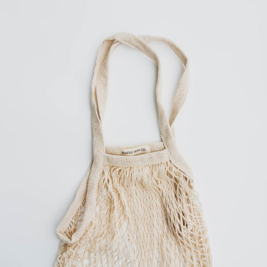 Cotton string tote bag with "French Market" text from Seattle Seed Company, casual reusable shopping bag.
