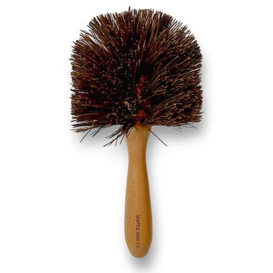 Seattle Seed Company plant pot cleaning brush with wooden handle and bristles for effective cleaning of plant containers.