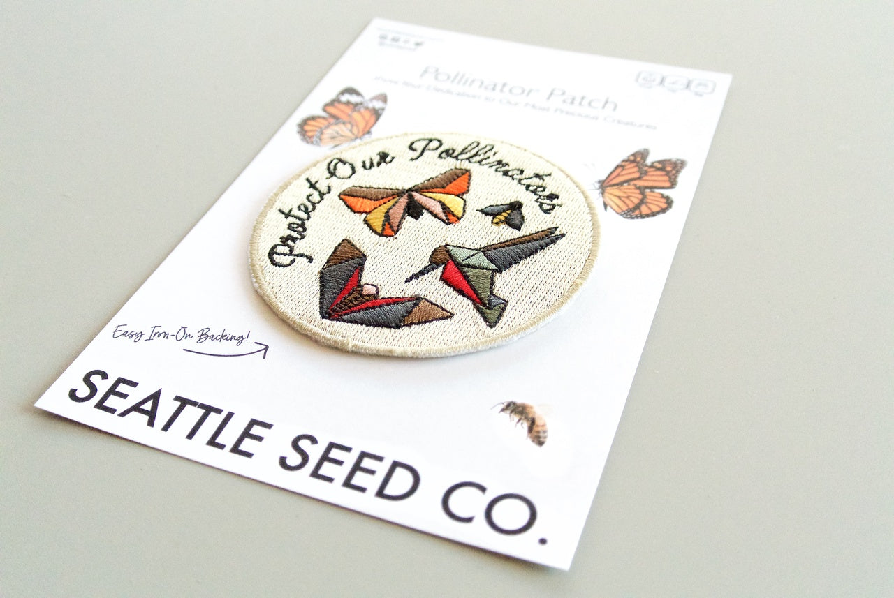 Pollinator Pride patch and sticker kit from Seattle Seed Company featuring colorful bee and flower designs for pollinator awareness.