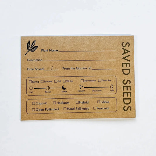 Seed saving envelopes from Seattle Seed Company, featuring paper envelopes with printed labels for storing and organizing seeds.
