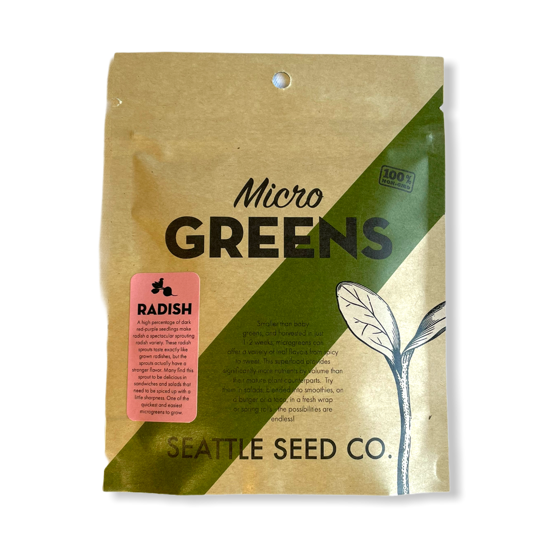 Fresh red radish microgreens from Seattle Seed Company, young sprouting microgreens on soil in a tray.