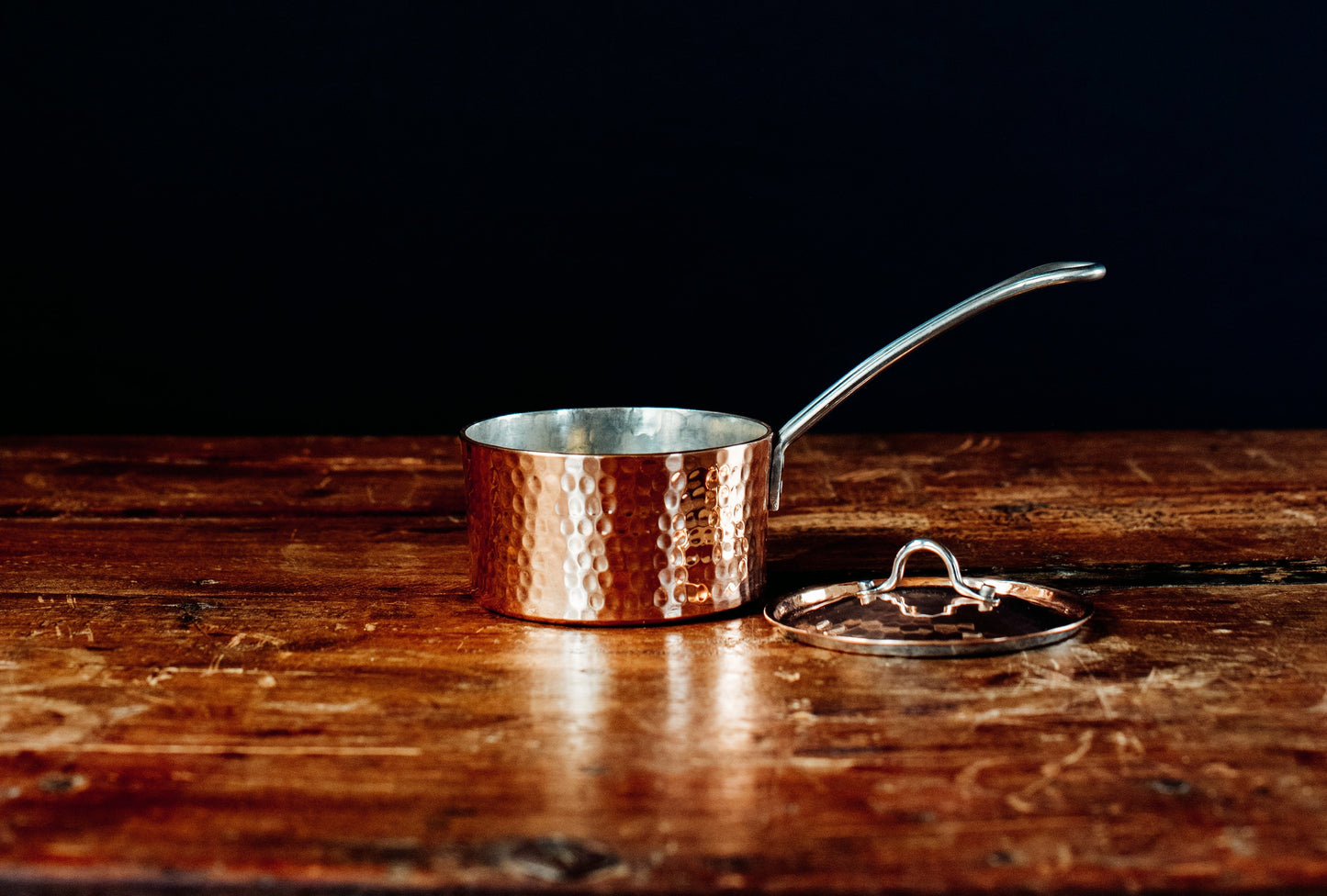 Side view of Sertodo petite French copper butter pot with lid, showcasing its shiny copper finish and compact design.