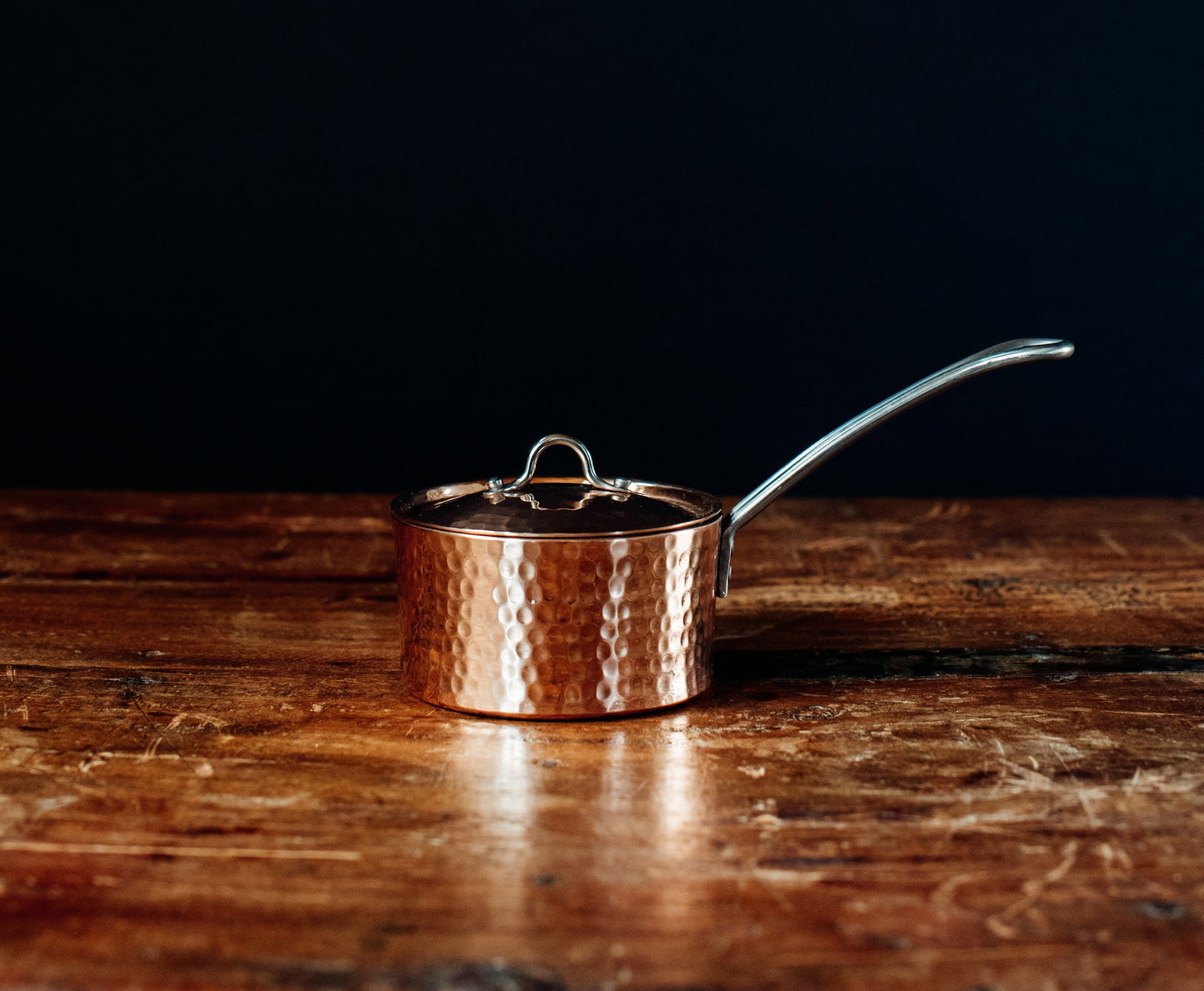 Side view of Sertodo petite French copper butter pot with lid, showcasing its shiny copper surface and compact design.