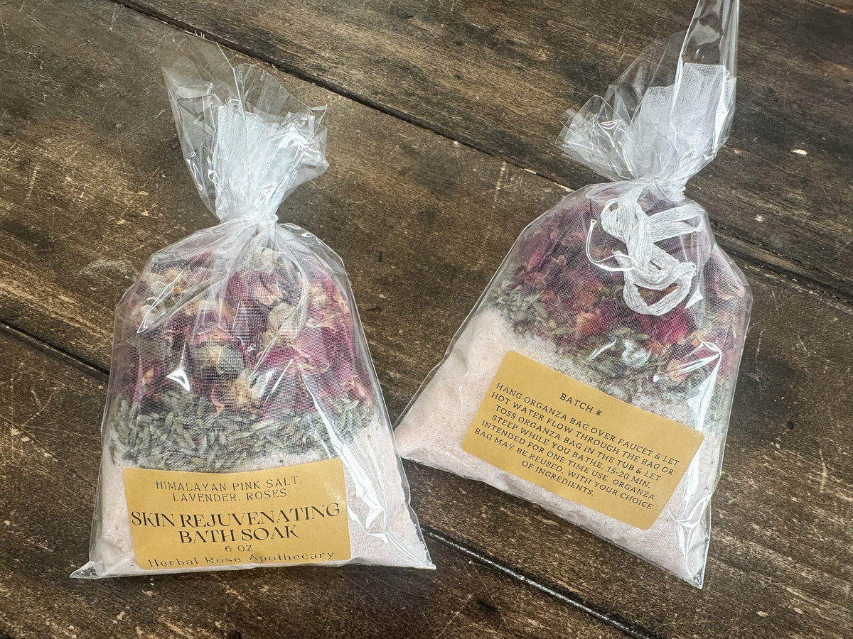Herbalroseapothecary skin-rejuvenating herbal bath soak with dried herbs and natural botanicals in a glass jar.