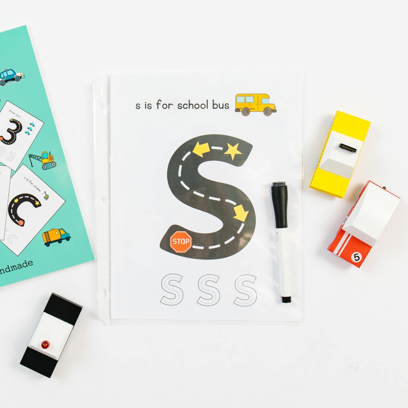 Coloring page from So Handmade Shop Road Trace Activity Book featuring alphabet and numbers for early learning.