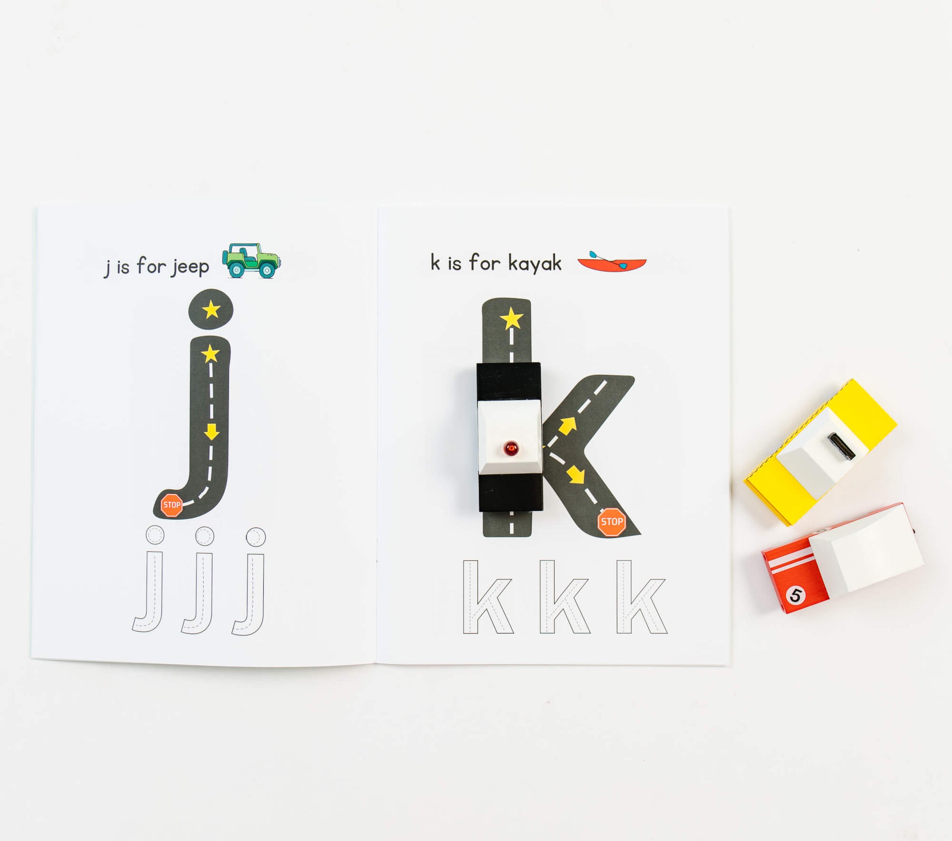 Coloring page from So Handmade Shop's Road Trace Activity Book with alphabet and numbers for early learning.