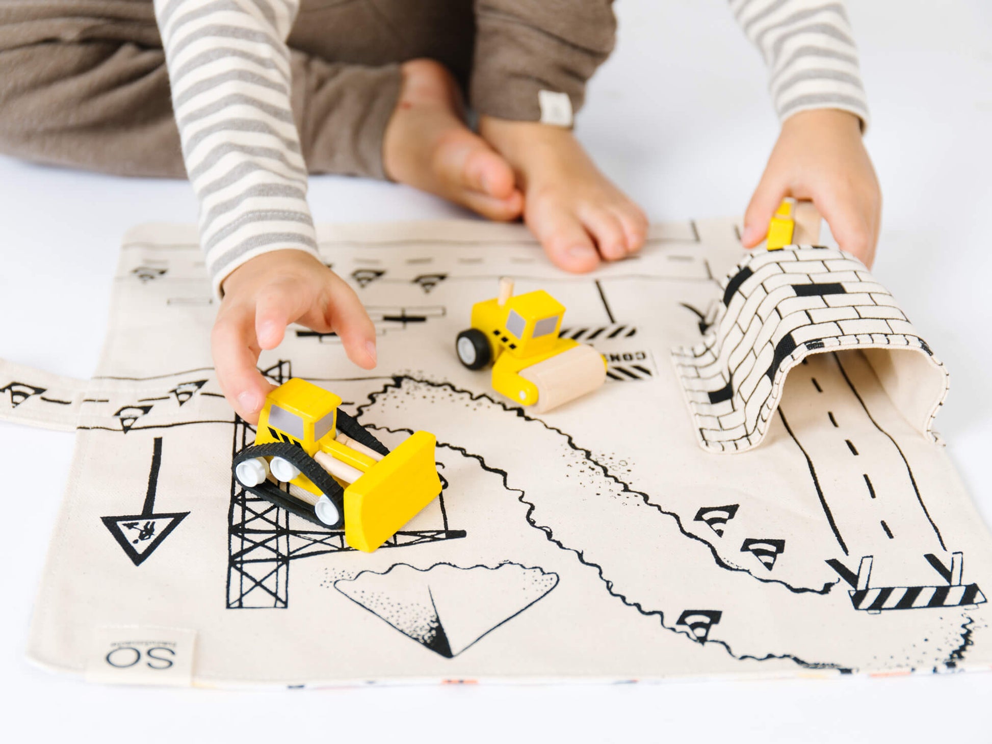 Construction playmat by So Handmade Shop featuring colorful construction vehicles and roads for imaginative building play.