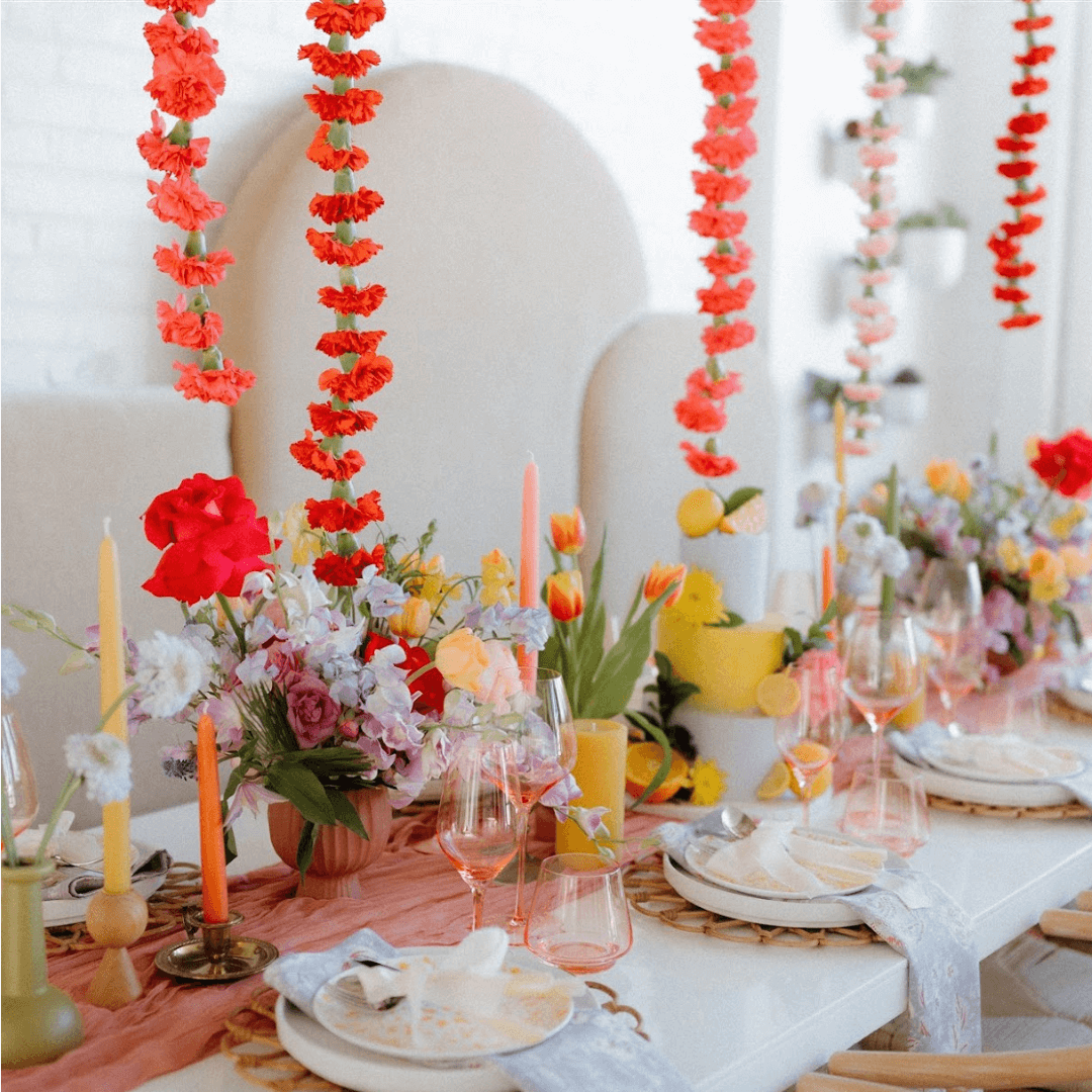 Set of four Bluecorn Candles spring beeswax taper candles in dusty rose, apricot, pistachio, and raw colors for a boho wedding table.