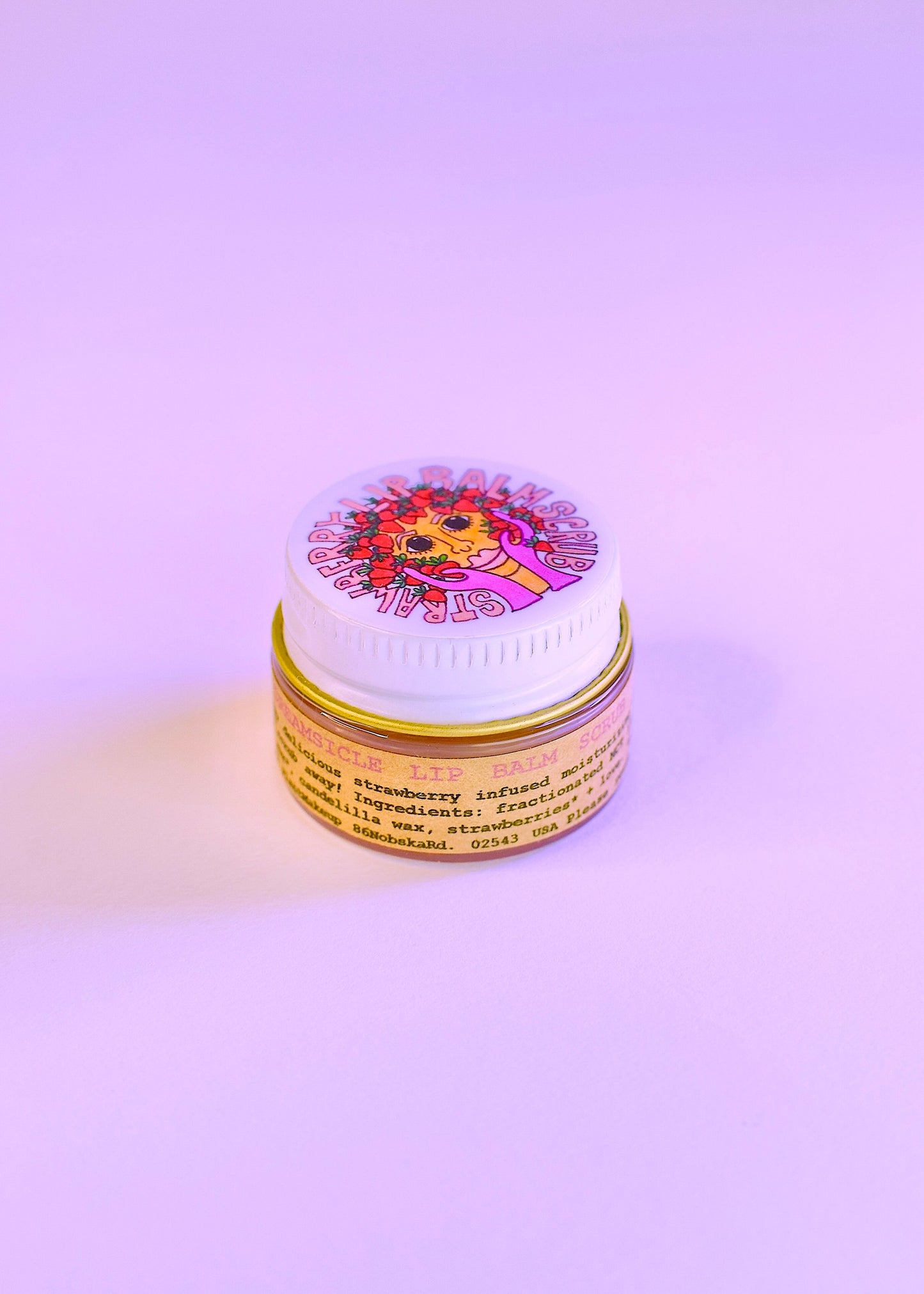 Plant Makeup Strawberry Dreamsicle Lip Balm Scrub in a jar with pink and white creamy texture, featuring fresh strawberry pieces.
