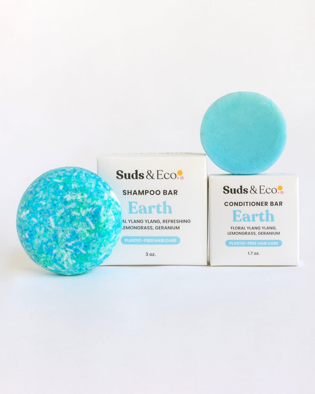 Two turquoise Shampoo & Conditioner Bar Duos from ZeroWasteStore.com sit on white boxes labeled "Earth," scented with ylang ylang, lemongrass, and geranium—ideal for a zero waste hair care routine.