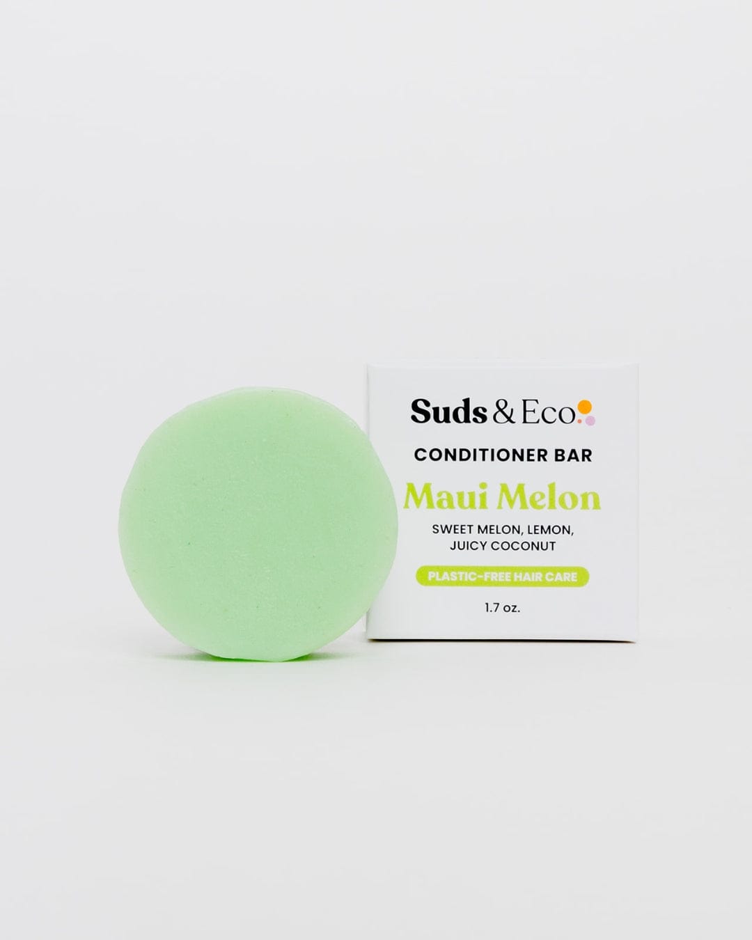 A light green round Conditioner Bar from ZeroWasteStore.com sits by its box, labeled Maui Melon with sweet melon, lemon, and coconut scents. Sulfate free hair care, 1.7 oz., on a white background.