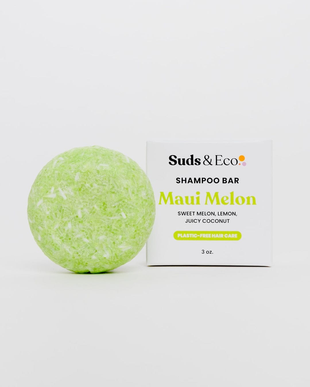 A light green, round Shampoo Bar by ZeroWasteStore.com sits next to its white box. Scented with sweet melon, lemon, and coconut. Vegan, zero waste, and plastic-free hair care; 3 oz., displayed on a plain white background.