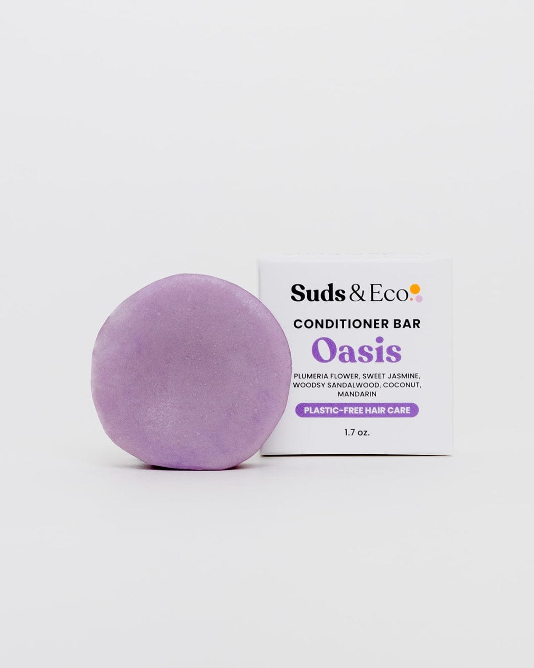 A round lavender Conditioner Bar by ZeroWasteStore.com rests beside its box, offering plastic-free, sulfate-free hair care with plumeria, jasmine, coconut, and mandarin scents for a zero waste routine.
