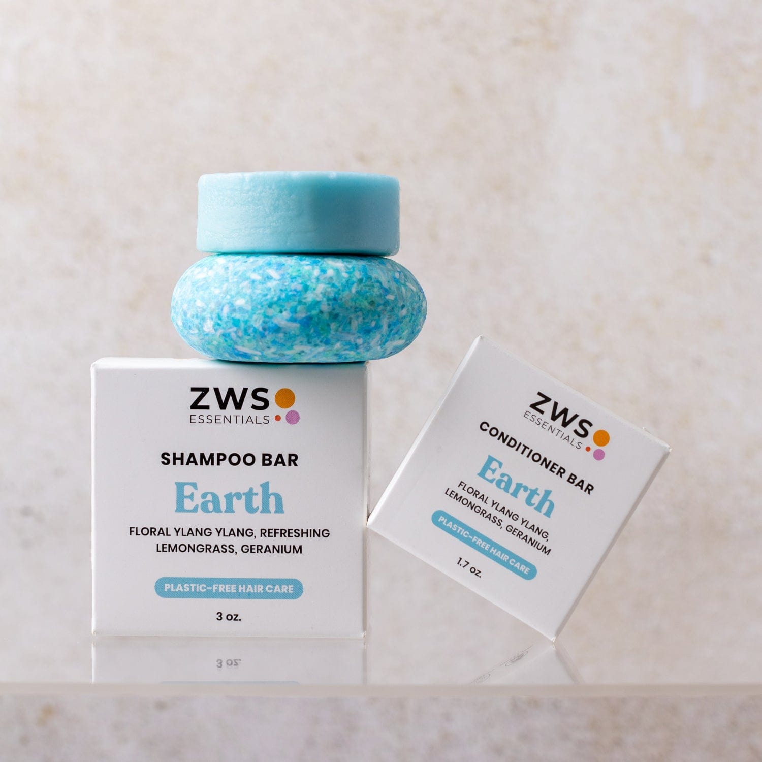 A blue Shampoo & Conditioner Bar Duo from ZeroWasteStore.com rests on a white zero-waste box, with the conditioner bar’s matching box leaning beside it.