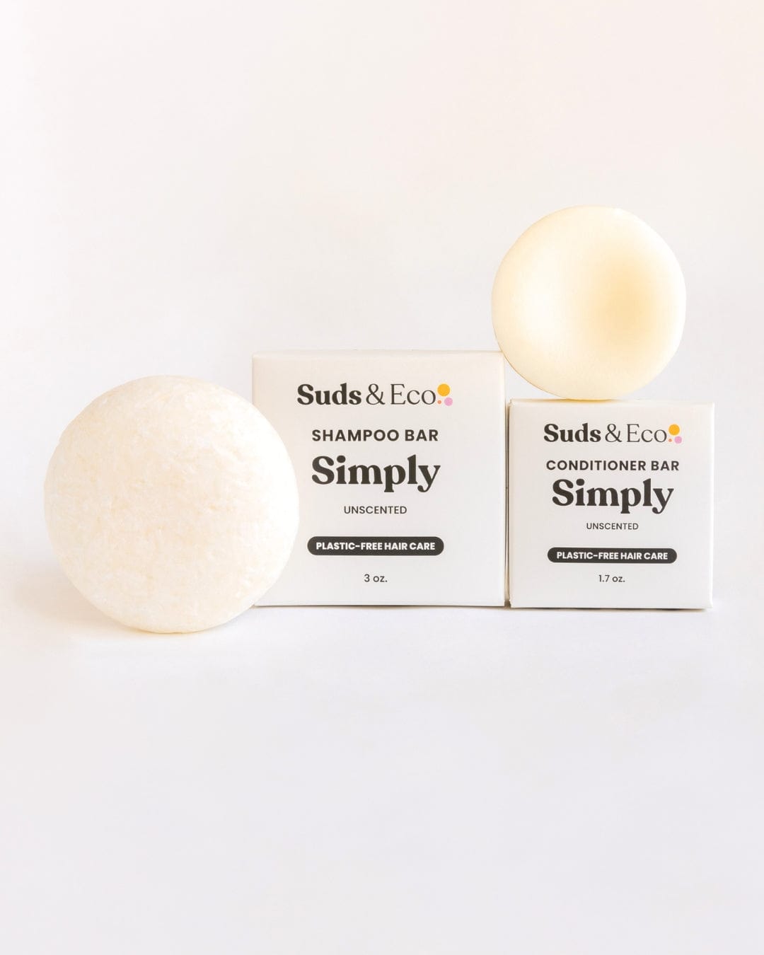 The Shampoo & Conditioner Bar Duo by ZeroWasteStore.com features two round white bars beside their boxes, offering zero waste, plastic-free hair care on a clean white background.