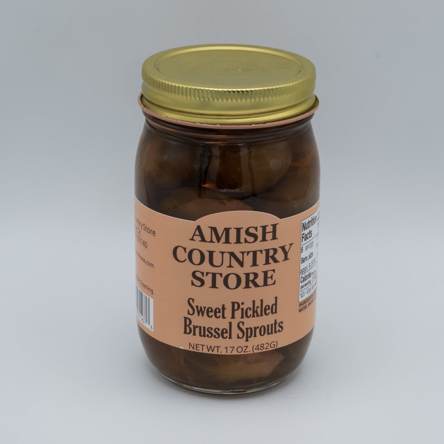 Canned sweet pickled Brussels sprouts from Amish Country Store in a jar, showcasing glossy, pickled green Brussels sprouts.