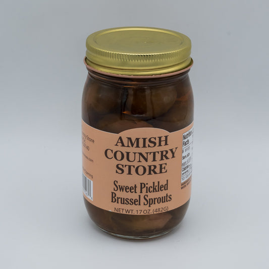 Canned sweet pickled Brussels sprouts from Amish Country Store in a jar, showcasing glossy, pickled green Brussels sprouts.
