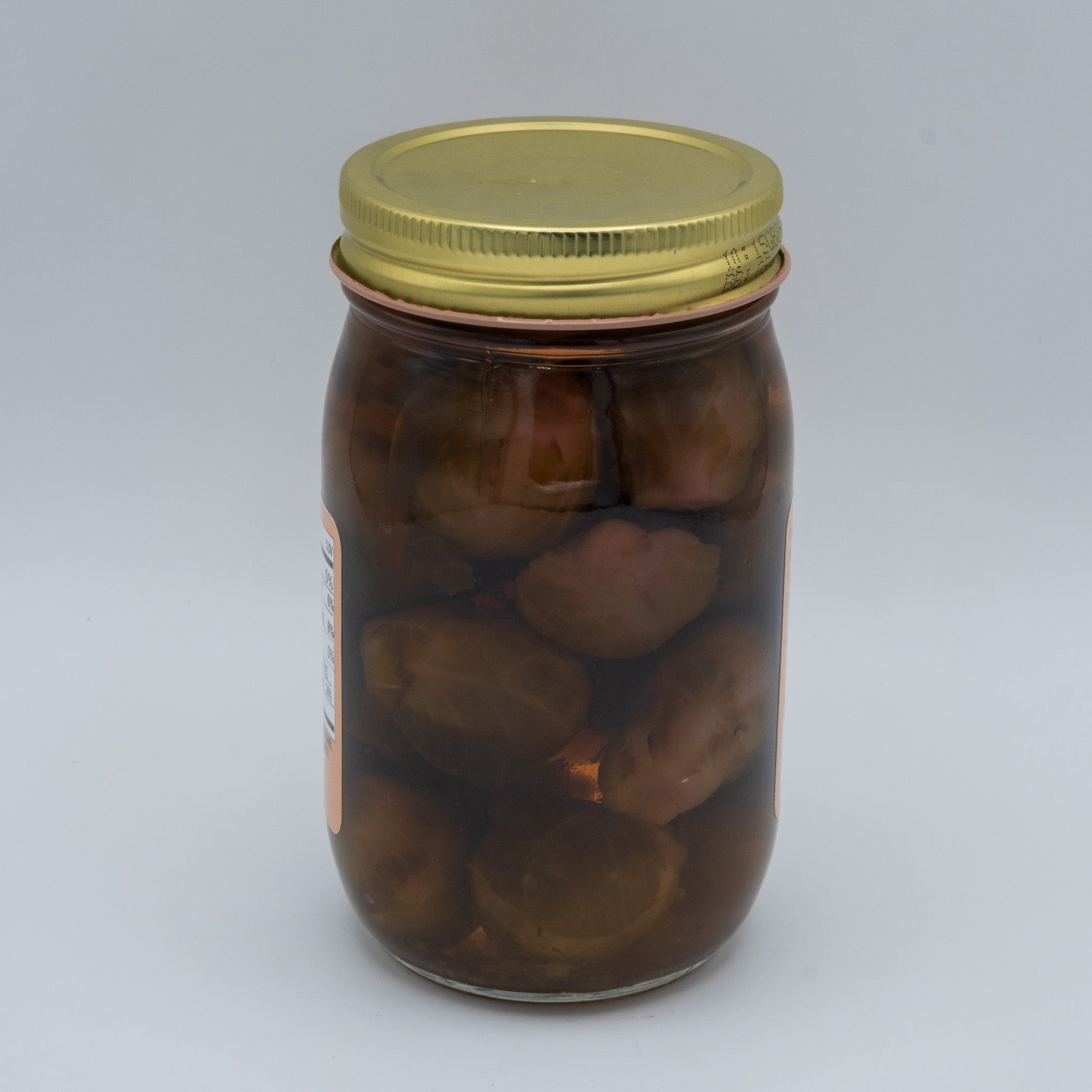 Canned Amish Country Store sweet pickled Brussels sprouts in a jar, showing glossy, pickled Brussels sprouts with a sweet glaze.