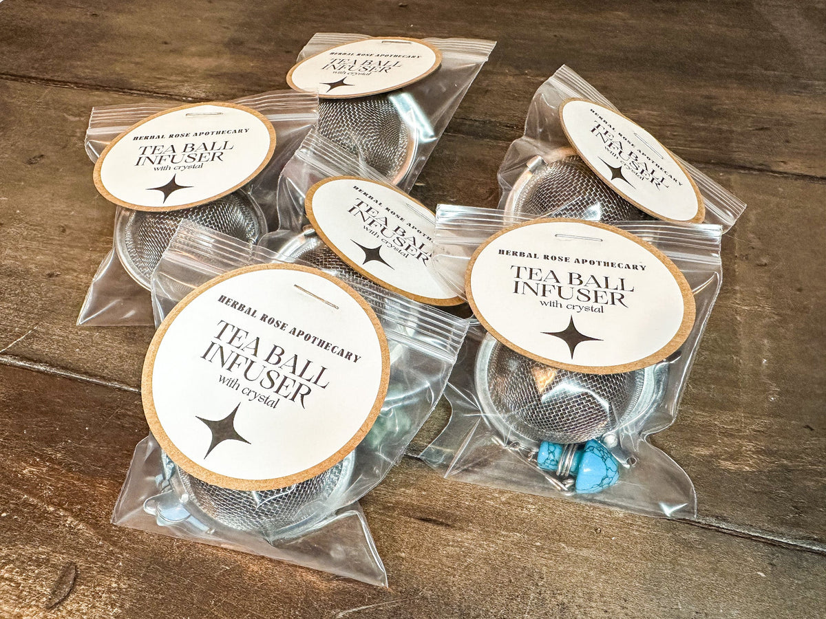 Herbalroseapothecary tea ball infuser with crystal, stainless steel mesh, and packaging, ideal for brewing loose leaf tea.