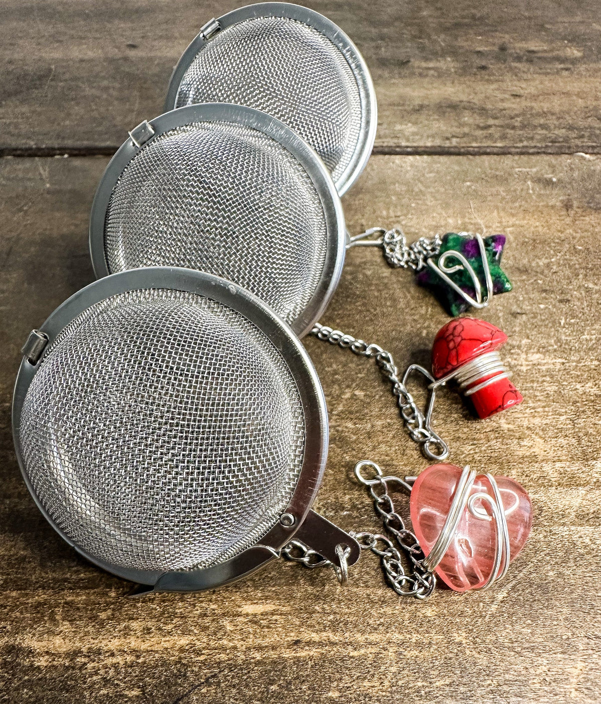 Herbalroseapothecary tea ball infuser with stainless steel mesh for loose leaf tea brewing, hanging loop for easy use.