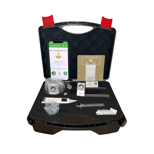 The TeraGanix microBIOMETER® Soil Testing Kit comes in a black plastic case with foam inserts and includes a digital device, syringes, tubes, a booklet, stickers, and QR code. An open phone shows the app screen with fungal to bacterial ratio results.