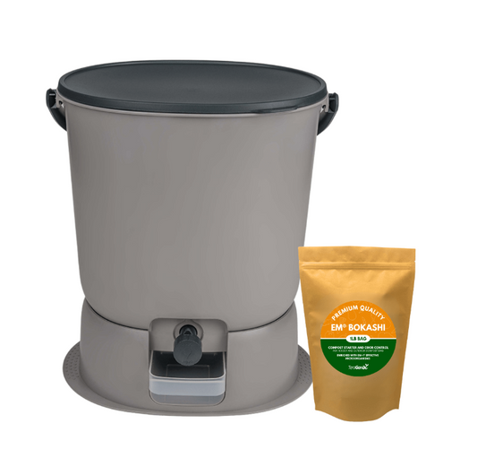 The Teraganix Wholesale Essential Bokashi Compost Bin Starter Kit (4.4 gal) features a gray bin with lid, drainage spout, and base tray, shown alongside a brown packet of EM® bokashi starter—perfect for easy indoor composting.