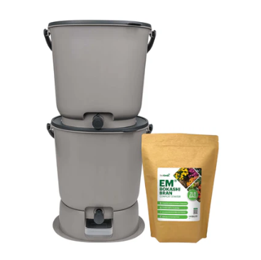 The Essential Bokashi Compost Bin Starter Kit, 4.4 gal by Teraganix Wholesale features two stacked gray bins with spigots and a brown EM® bokashi starter bag—ideal for easy indoor food waste composting.