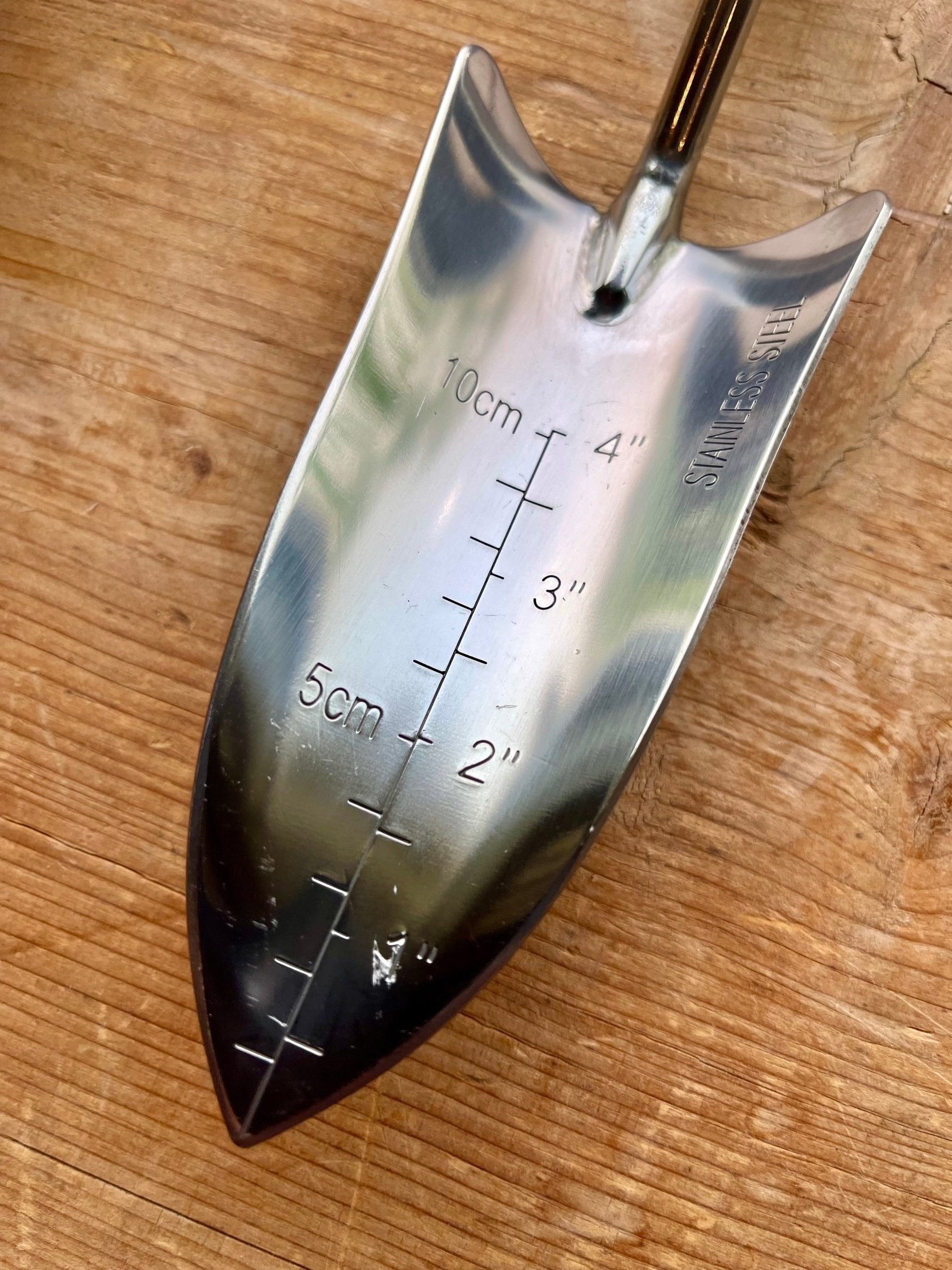 The Celtic Farm Potters Tool Set includes a metal trowel with measurement markings from 2–10 cm and 1–4 inches—a perfect potting addition or garden tool gift.