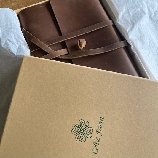 The Leather Garden Journal and Diary by The Celtic Farm is partially visible inside a beige, tissue-lined box—perfect for garden planning, thoughts, and design notes.