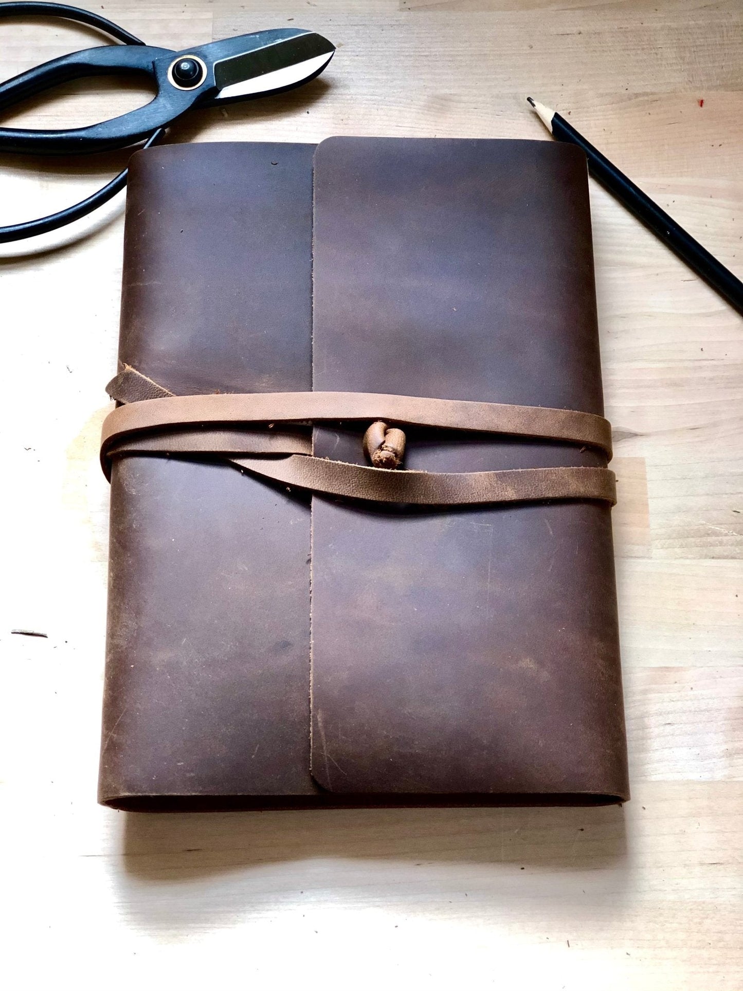 Leather garden journal by The Celtic Farm featuring pages for garden planning, design, and thoughts in a classic notebook style.