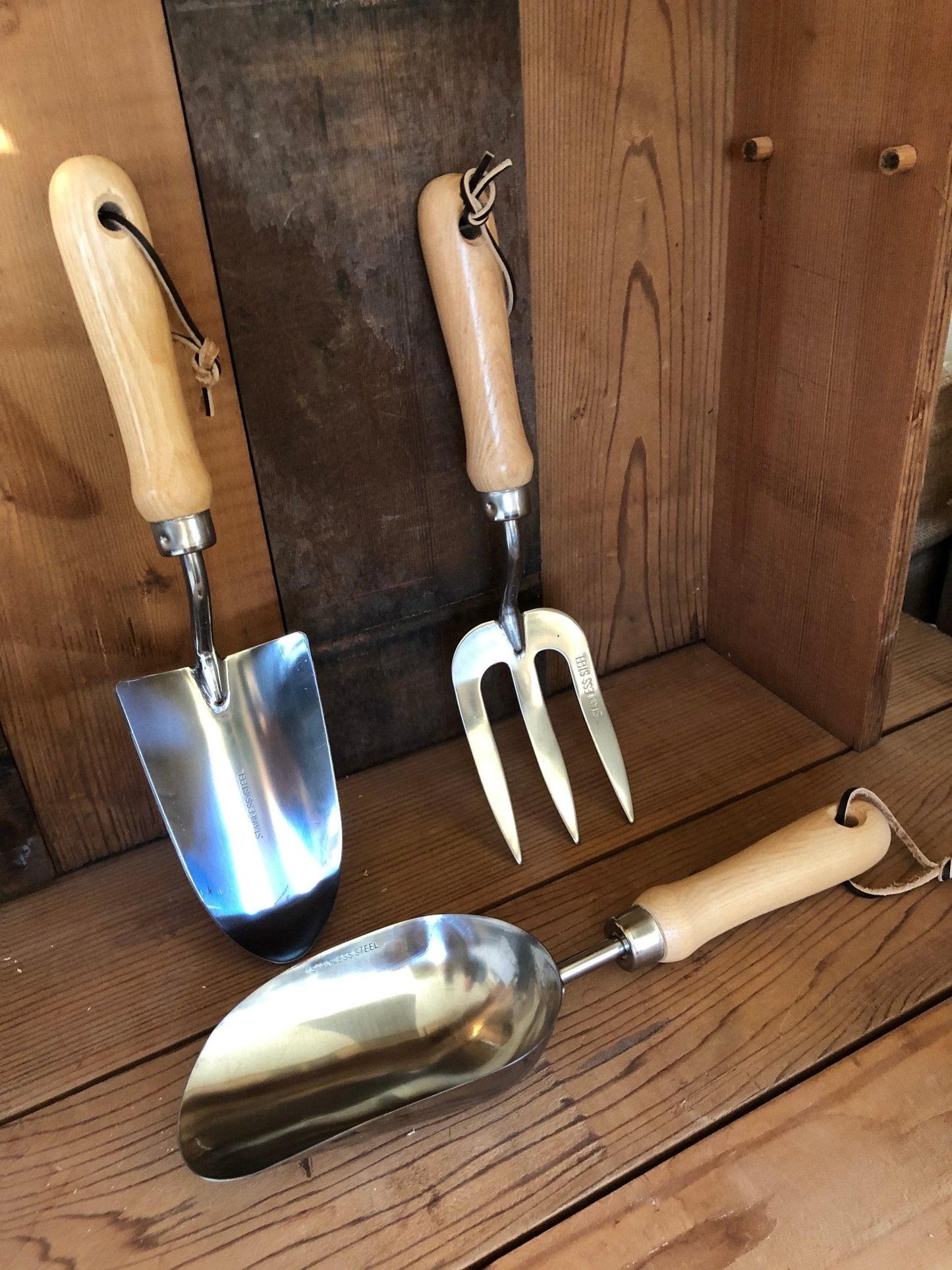 The Celtic Farm’s Garden Hand Tool Set - Hardwood and Stainless includes a trowel, hand fork, and scoop with wooden handles and leather loops. Durable stainless steel heads make this set perfect for all your gardening tasks.