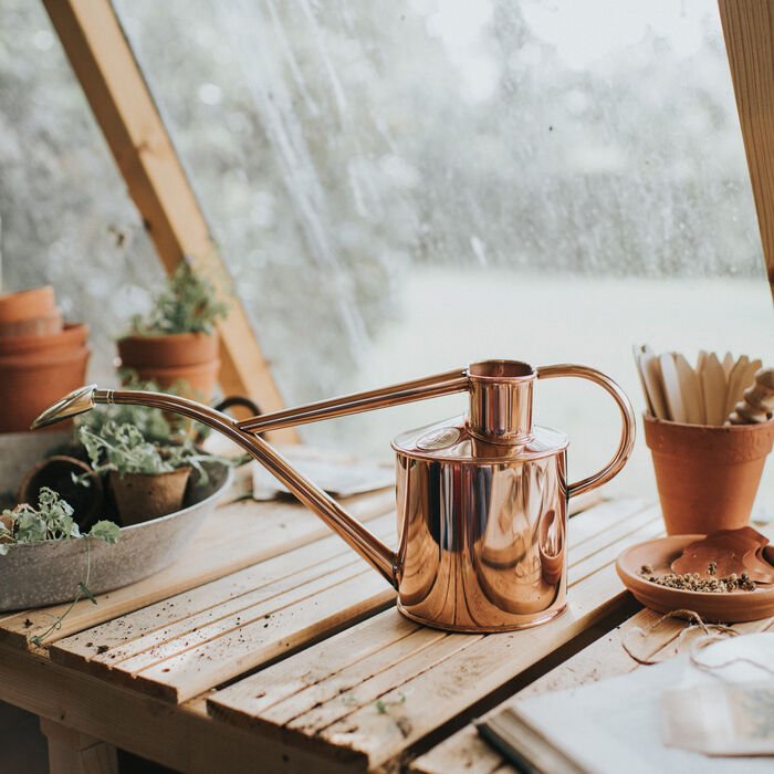 Dark green Haws Rowley Ripple watering can from The Celtic Farm, featuring a textured design and ergonomic handle for easy watering.