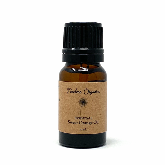 Fresh sweet orange from Timeless Organics Skin Care, showing vibrant orange fruit with textured peel and bright, juicy interior.